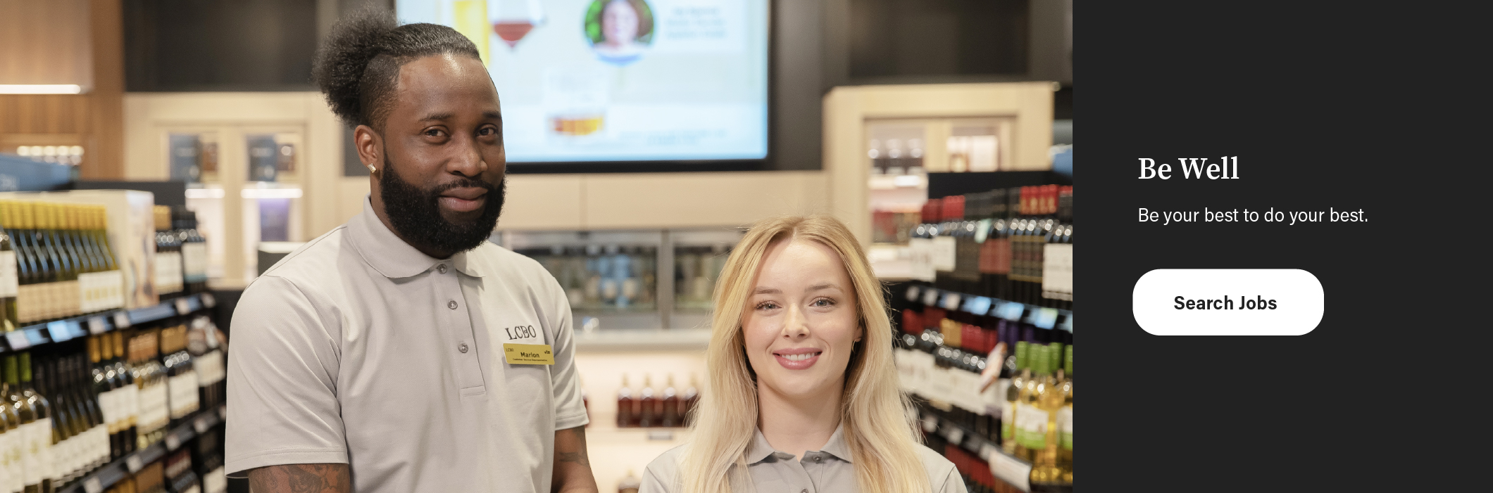 Two smiling LCBO employees standing in a retail store  representing friendly customer service and our welcoming atmosphere.